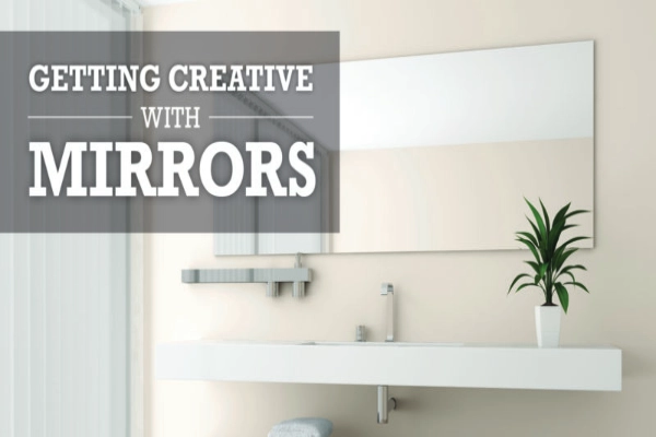 Modern bathroom with a large mirror above a white sink.