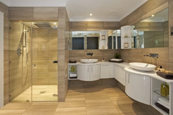 A modern bathroom featuring a walk-in shower and double sinks.