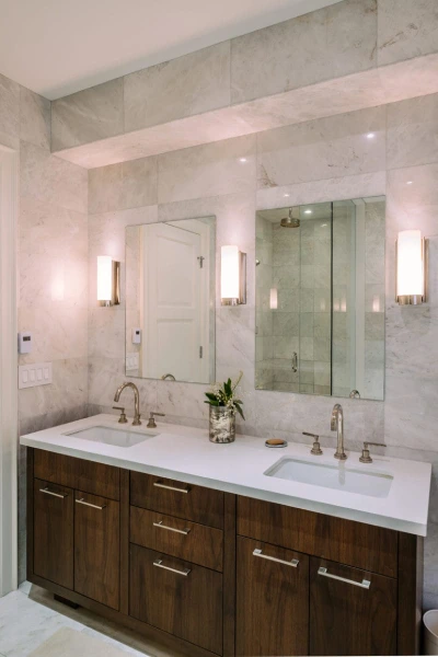 A modern bathroom featuring elegant marble countertops and a spacious double sink.