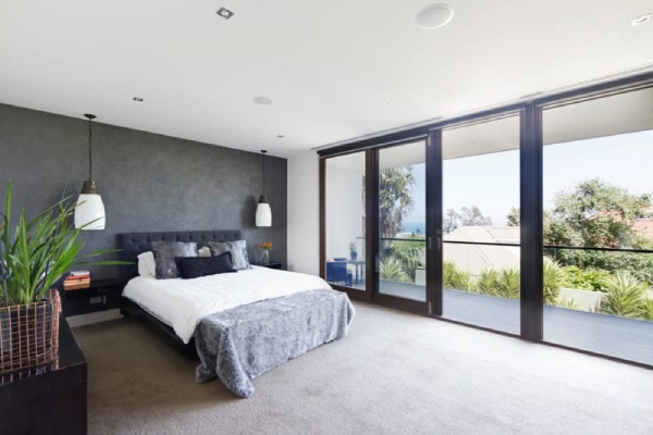 Modern bedroom with large windows.