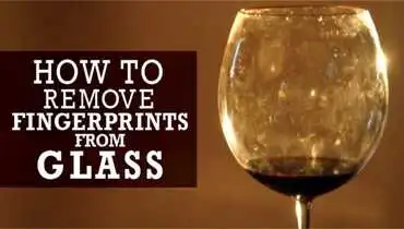 A dirty wine glass with water spots