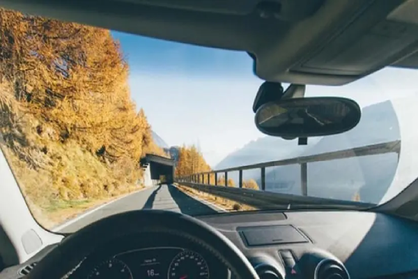 A car drives along a winding mountain road.