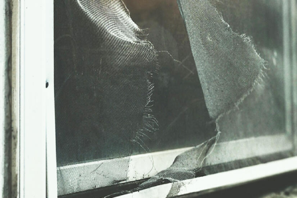 A damaged window with fabric protruding