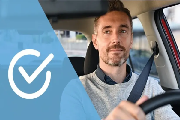 Man driving car and looking in his rearview mirror.