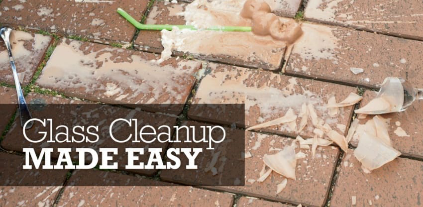 A broken glass dish on a brick pavement