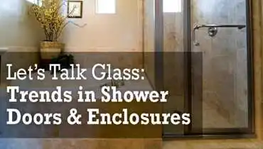 A bathroom with a tub and framed glass shower