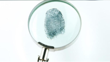 A magnifying glass over a fingerprint