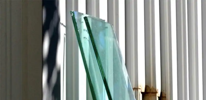 Two sheets of glass leaning against a wall