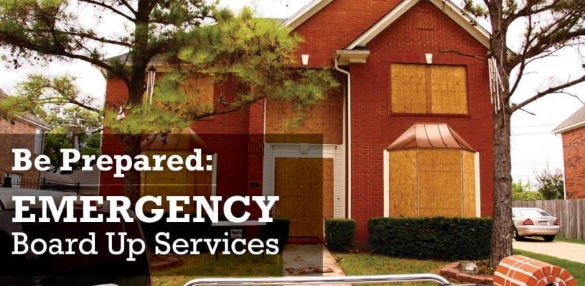 Two story house with boarded windows and doors