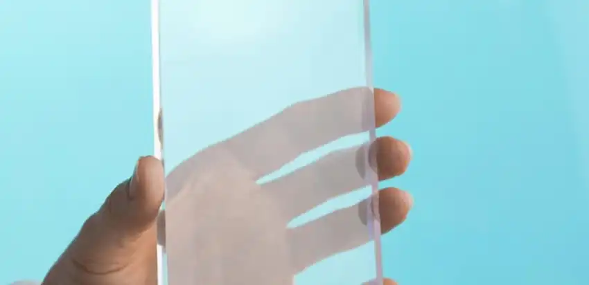 A piece of plexiglass being held up by a hand
